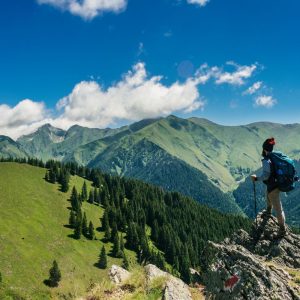 Cascade 28L trail pack standing on a hillside