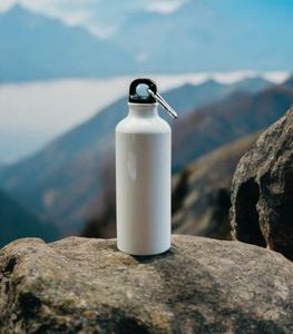 Insulated stainless steel water bottle on rocks