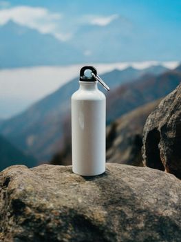 Insulated stainless steel water bottle on rocks